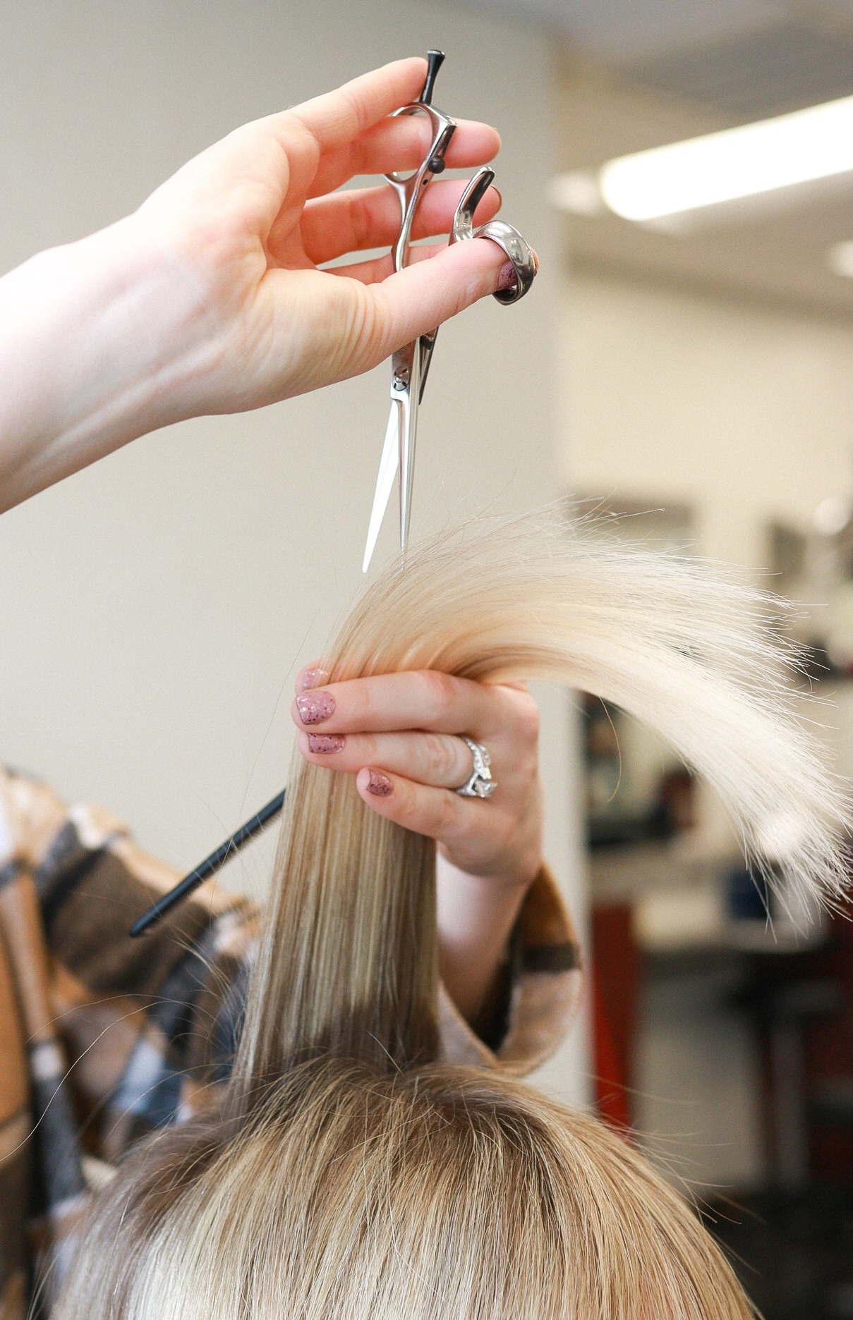 Close up of a cutting technique on blonde hair